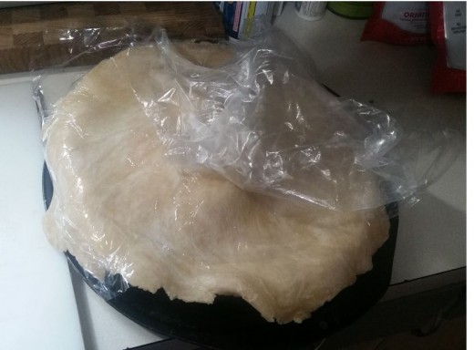 Top crust is placed directly on top of frozen fruit and overlaps the edges. Begin to remove the plastic wrap