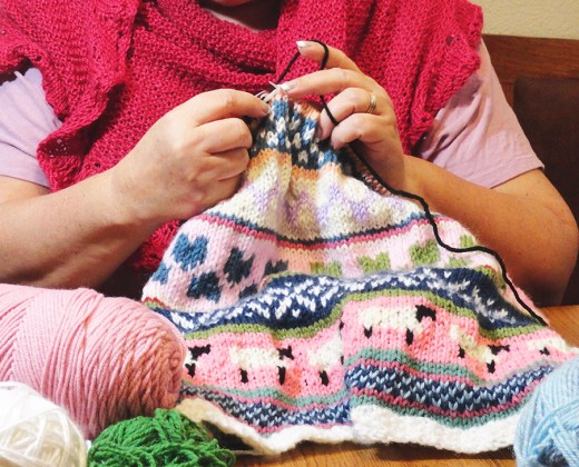 Happily Knitting a Fair Isle Baby Blanket for my grandchild.