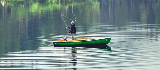 Fly fishing from a boat on a lake.
