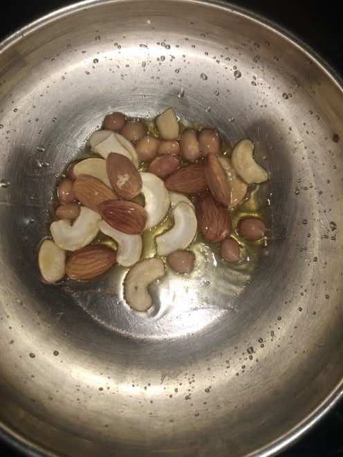 Heat ghee in a pan, fry almonds, cashews and peanuts.