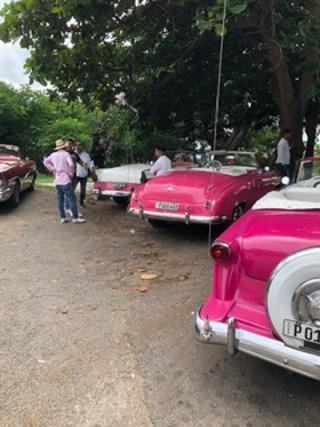 Cuban classic cars. This scene of vintage cars and drivers is repeated throughout the city. Love that pink!