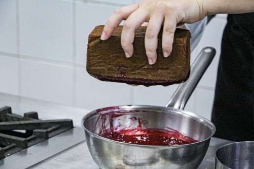 When the cake is firm, dip it into the raspberry confit (Step 10)