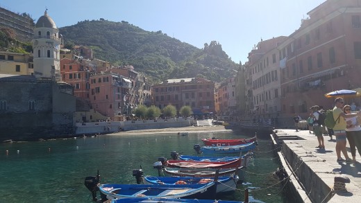 View of Vernazza from the harbor with colorful fishing boats