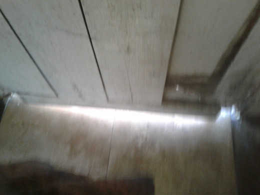 A gap under the wooden door lets in all the elements