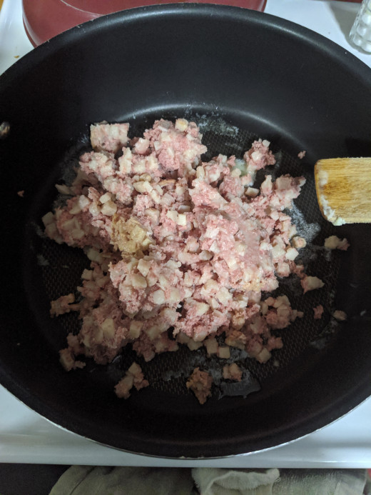 corned beef in frying pan, spread across pan