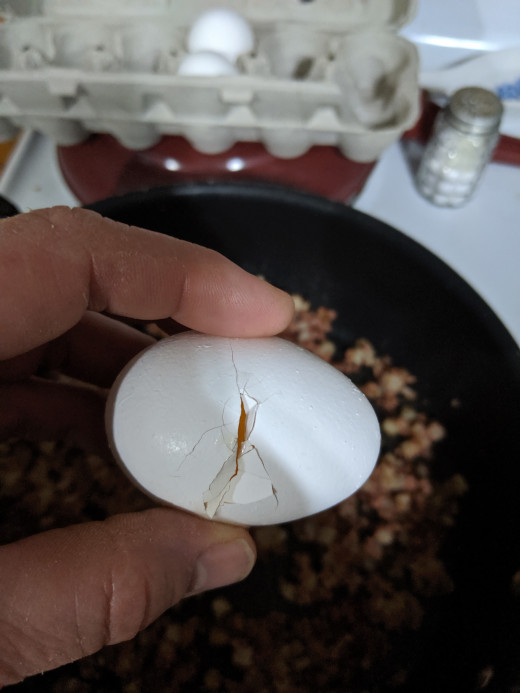 The tapping causes a crack that you can hook your thumbs into and pull apart and drop the egg onto the hash.