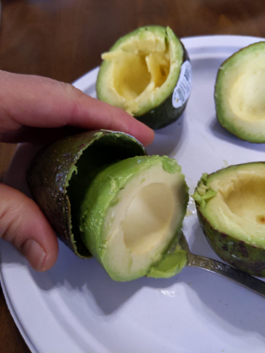 Spoon to loosen and gently pop avocado from the peel.