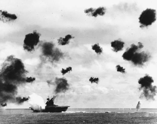 The USS Yorktown struck by a torpedo dropped by a Nakajima B5N.