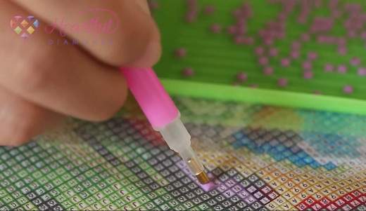 Start sticking diamond beads into the canvas according to the pattern guide.