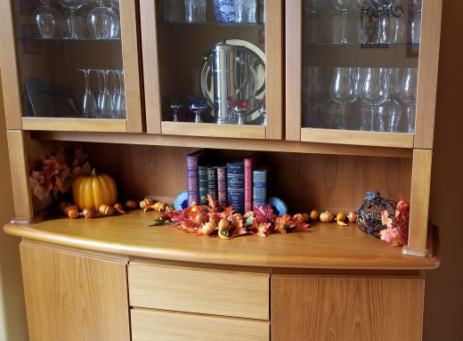 Faux pumpkins, gourds, and leaves add that fall feeling. These store away easily for use year-after-year. 