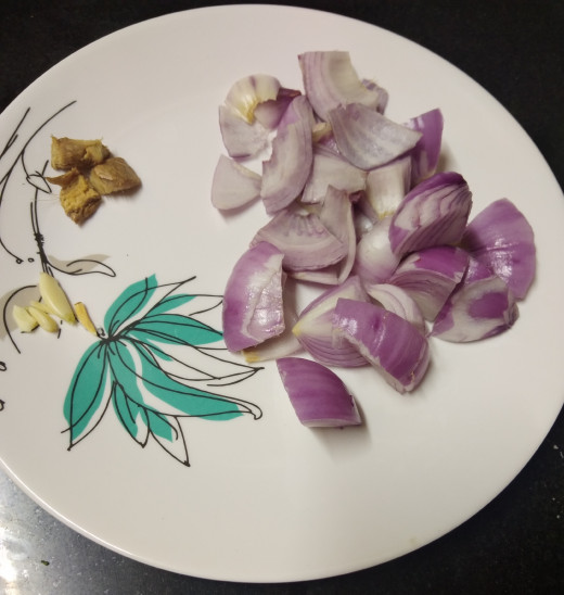 Roughly chop onions, and ginger. Remove skin of garlic. Keep aside. (skip ginger and garlic if you are using store brought ginger-garlic paste).