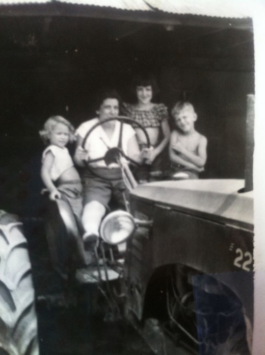 Four-year old me, sharing a tractor ride with my cousins from Ohio.