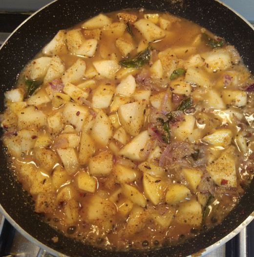 Add 1/2 cup of water or as required to cook potatoes.