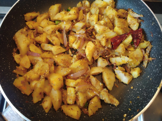 Mix till spices coated properly on potatoes. Once the spices are tossed well, fry in medium flame for 2-3 minutes.