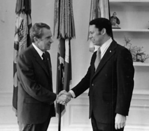President Nixon shakes hands individually with White House Fellow Colin Powell.