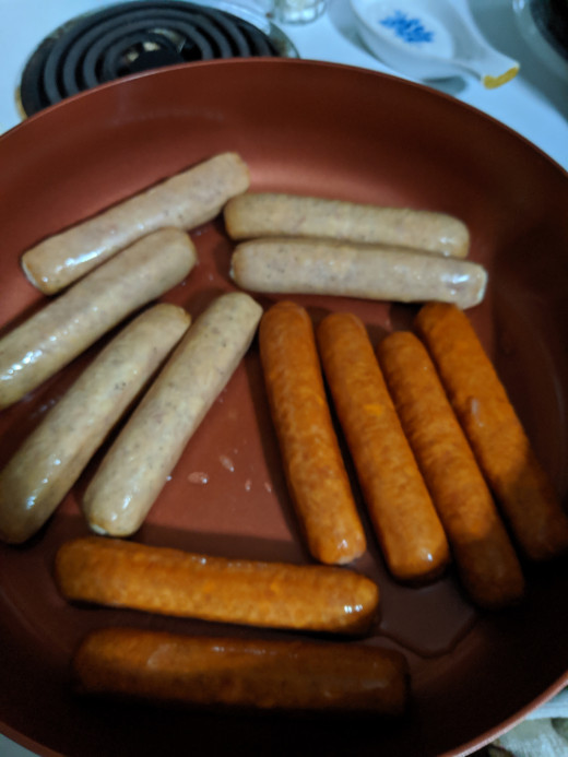 Brats and water in pan