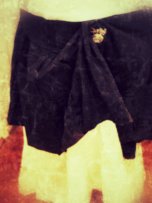 Black skirt over white skirt with vintage rhinestone pin