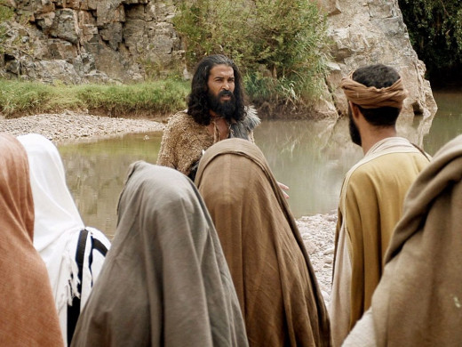 John the baptist talking to followers by the riverbank 