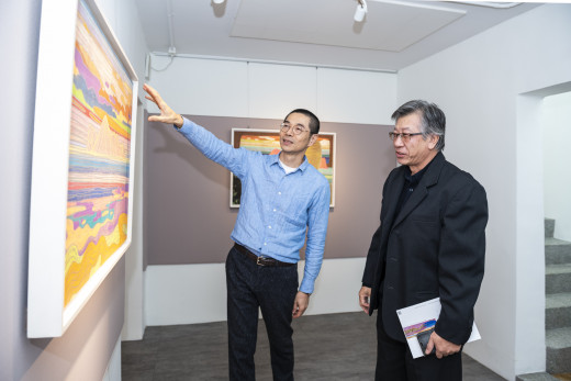 Mr. Wu is guiding during the opening reception.