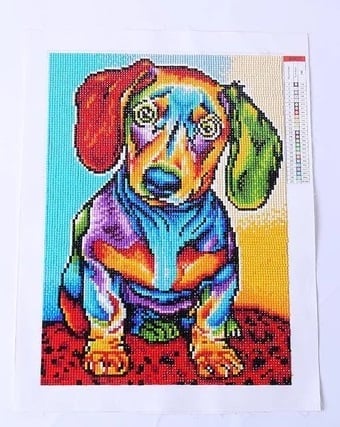 Finished multi-colored diamond painting of a dog