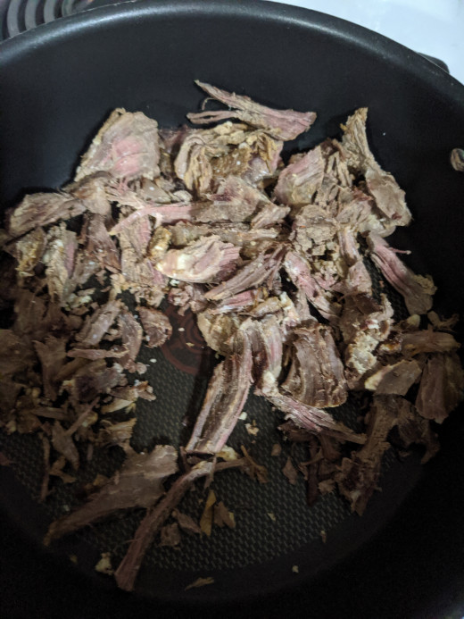 Meat and water in pan
