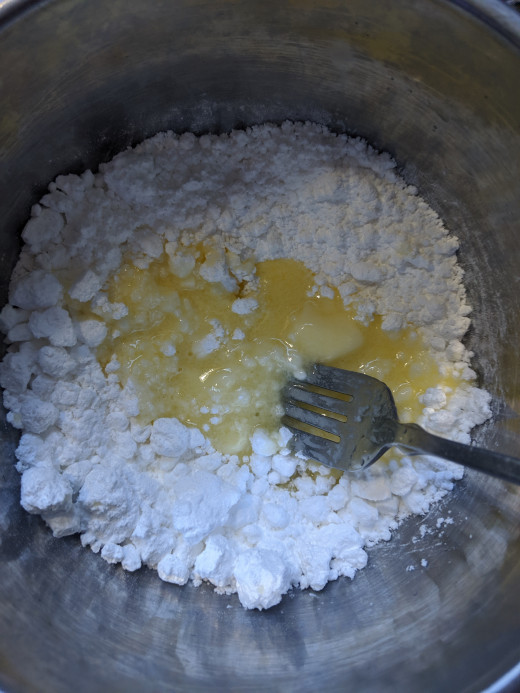 Pour butter into powdered sugar