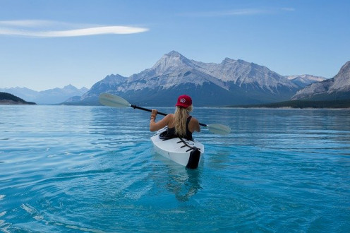 Adventure and Travel image-woman : This is an image of woman in a kayak in an icy region.