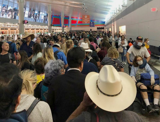 In this photo provided by Austin Boschen, people wait in line to go through the customs at Dallas Fort Worth International Airport in Grapevine, Texas, on March 14, 2020. Austin Boschen—AP