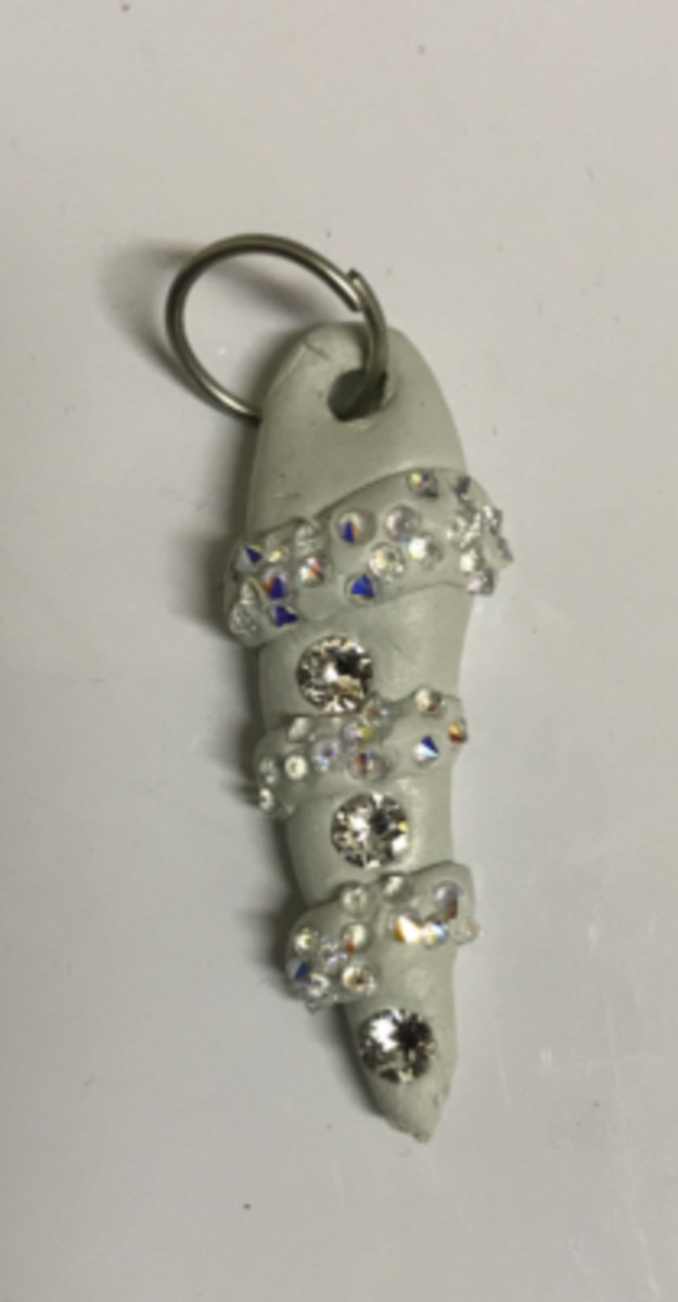 Here, I made a pendant in a shape of an abstract icicle, with chatons embedded. I wrapped small snakes, with nail caviar embedded in them via dipping, around it for an icy look. 
