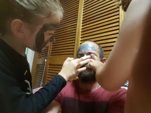Our daughter and I putting a face mask on Scott, which I have also done on our alone date nights.