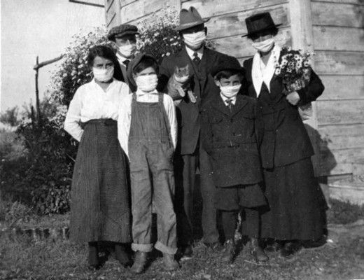 Family wearing masks during the 1918 pandemic (note the cat!)