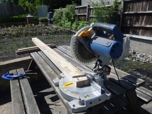 Trimming the ends of the old doorframe square with an electric mitre saw.