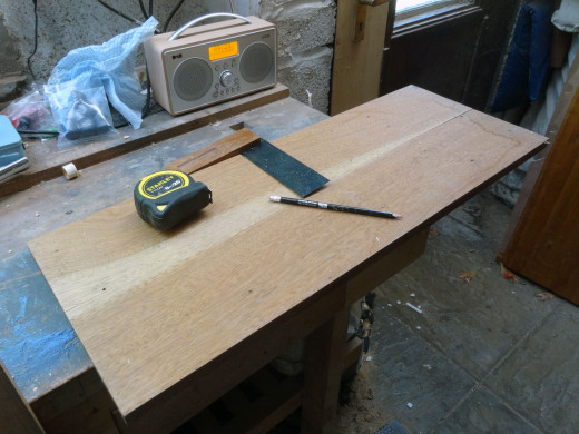 Marking out the wood for cutting the shelves to size.