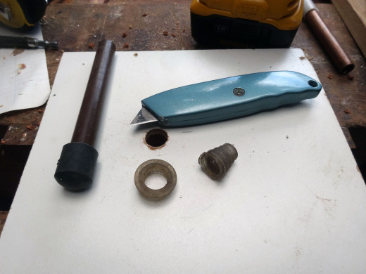 Rubber pipe stopper for pond water feature repurposed into washer with a Stanley knife.