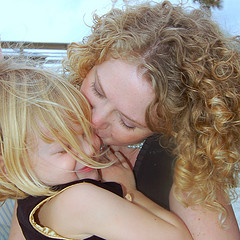 Mother kissing her daughter
