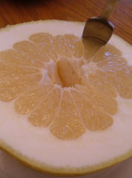 A grapefruit cut in half, ready to be eaten. This image is in the public domain.