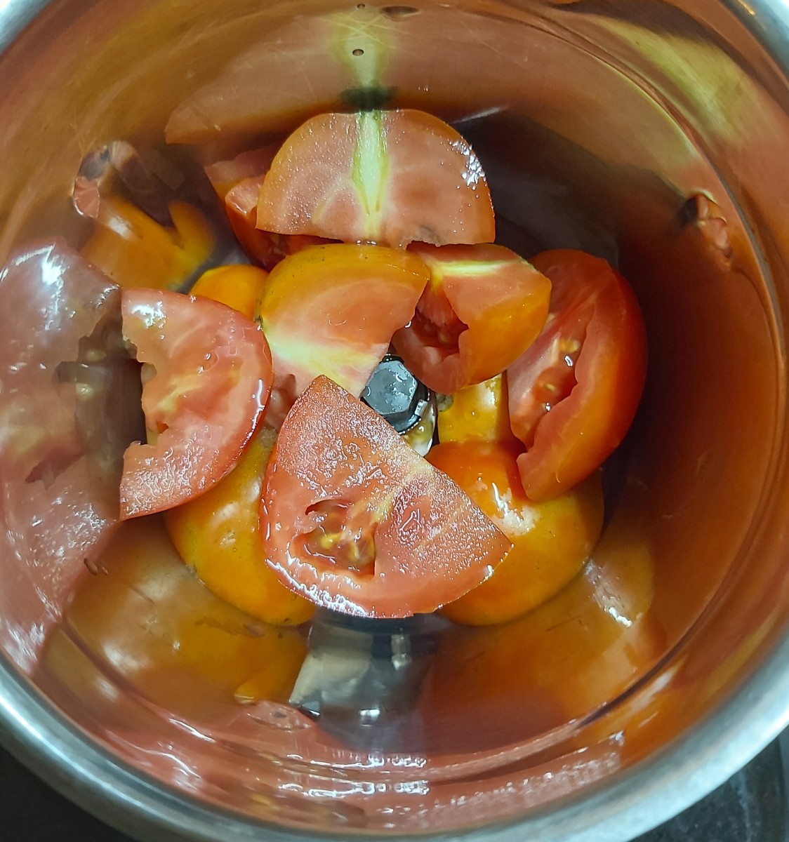 In a mixer jar take 2-3 roughly chopped tomatoes.