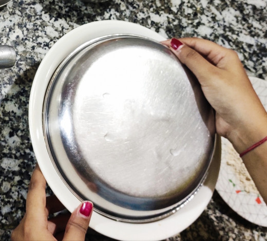 Covering the  dough with a plate