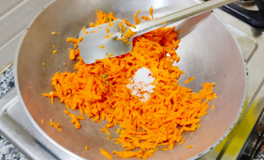 Salt added to carrot on wok