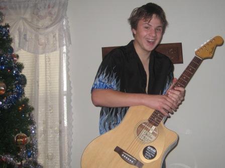 Matthew Schulze and his Fender electric acoustic guitar, Christmas 2008.