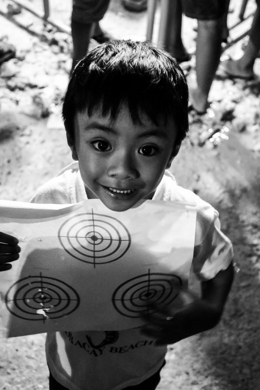 Little boy receiving a dart game toy