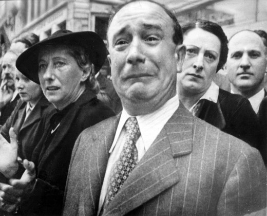 A French man in Marseilles crying as French army banners of dissolved units are evacuated to North Africa: war and defeat were no light matters in 1940