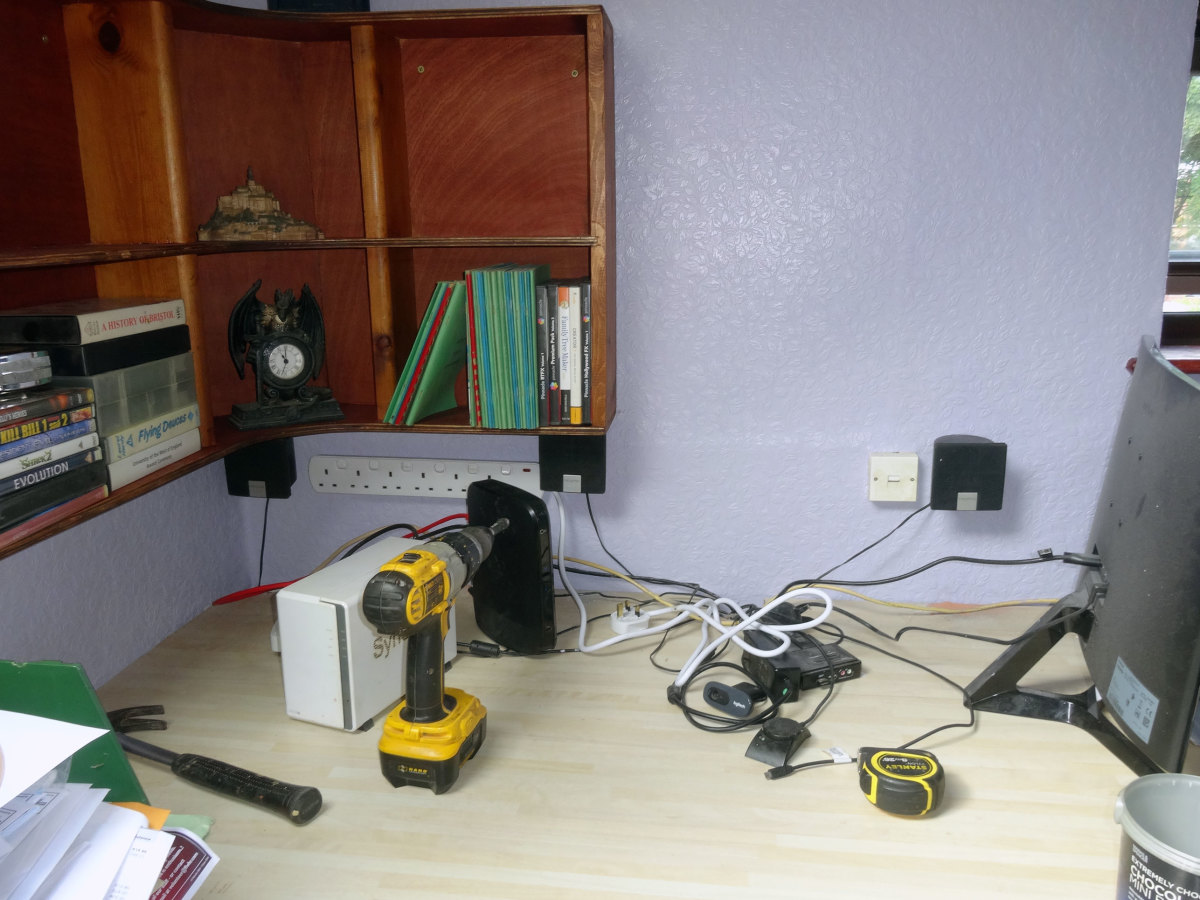 Front speakers fixed to wall at back of desk, as part of the makeover