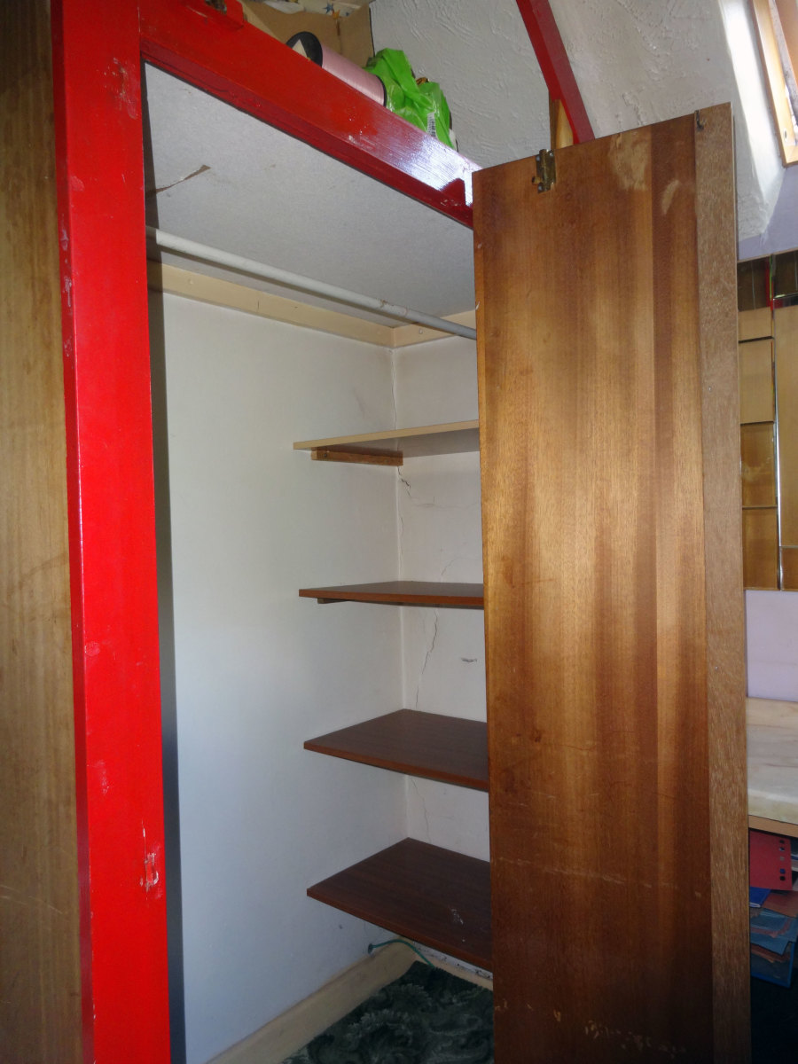 The large shelving around the corner, behind the clothes rail, to be removed as it was not very accessible