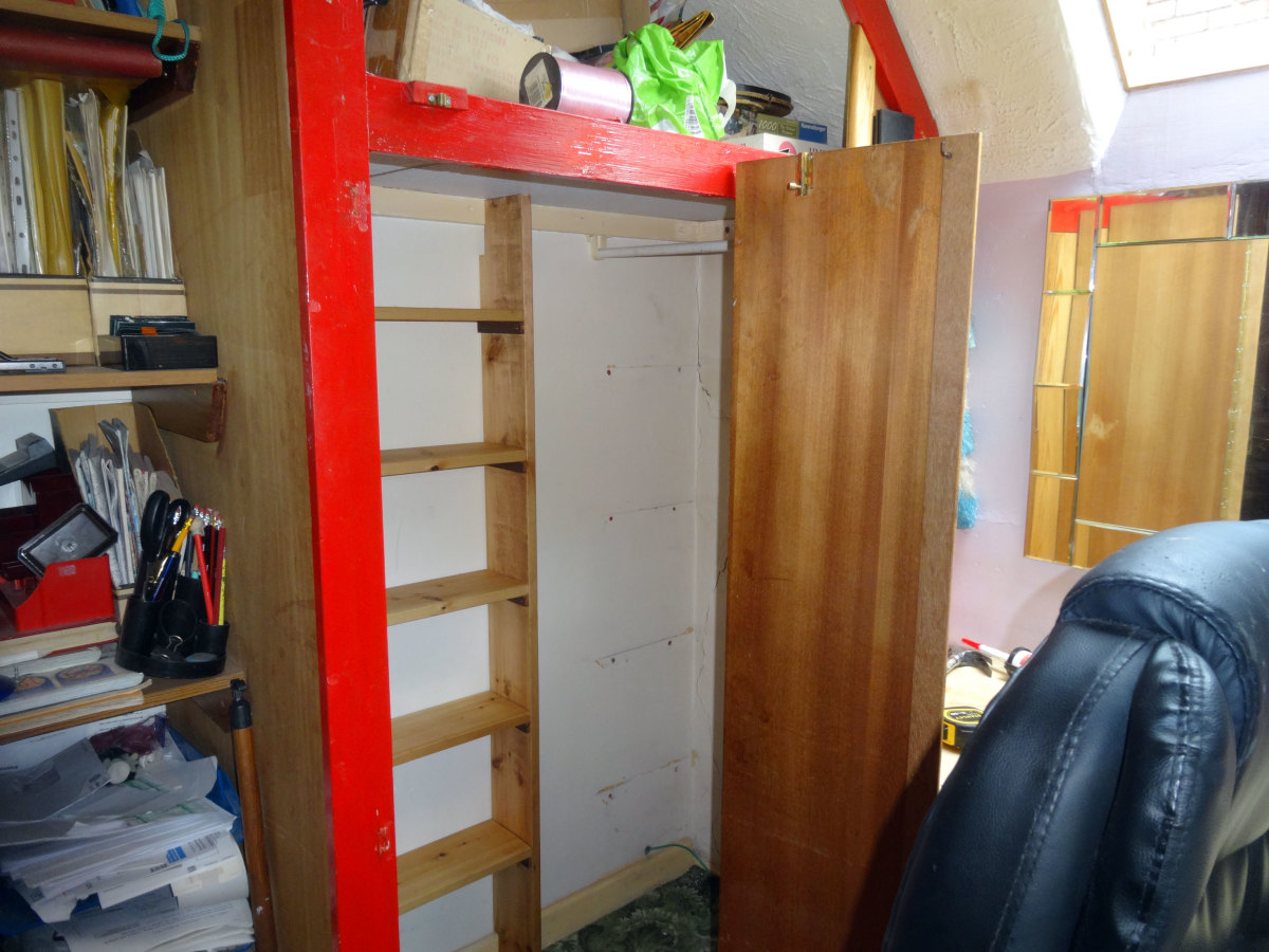 View showing the relocated clothes rail, turned around by 90 degrees, creating a mini-walk in wardrobe 