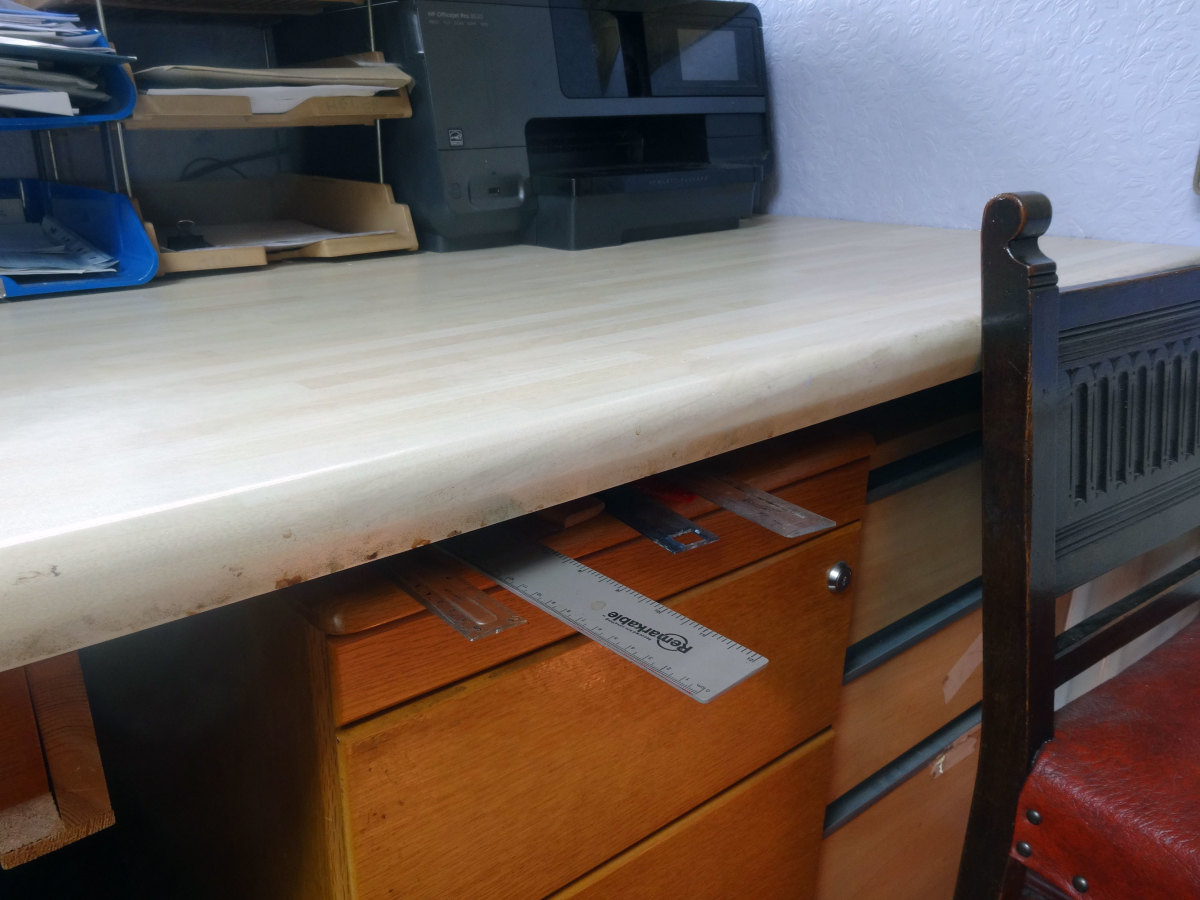 Using gap between one of the pedestals and desk for keeping our rulers to hand.