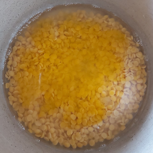Add 1 cup of water or enough to cook lentils, add 1/4 teaspoon of turmeric powder, salt to taste. 