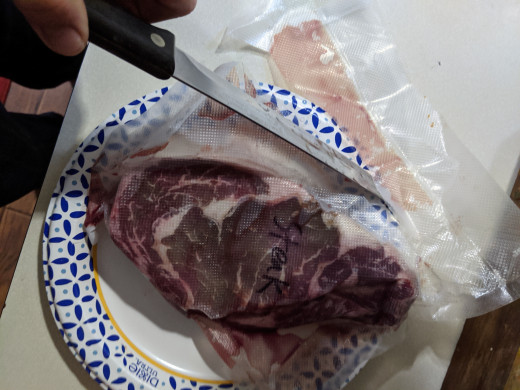 used knife to open package. I used my Foodsaver to package the steak originally.