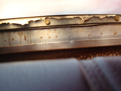This is the Back trim line behind rear seat, under the well. This fastens the bottom of the top rear quarters and rear window curtain to car. The ends are stapled to a tack bar behind this.