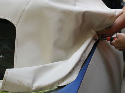 Stapling the rear quarter of the top to the Rear trim.